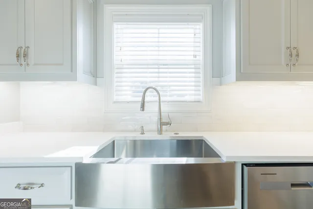 a kitchen with stainless steel appliances granite countertop a stove and a microwave