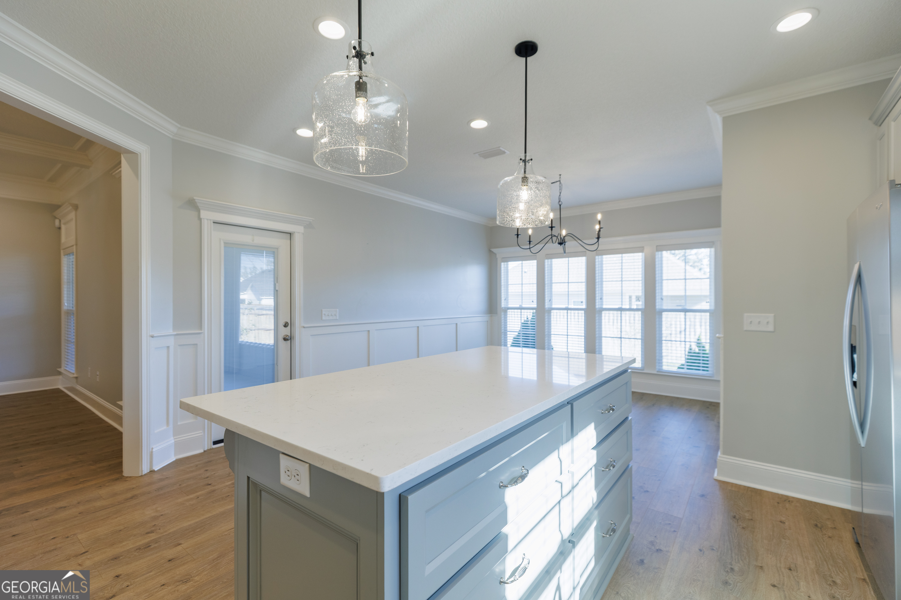 3001 Houser Way Hahira, GA 31632 - Photo 15 of 57 a view of a hallway with wooden floor and chandelier
