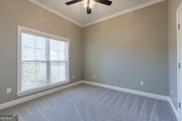 a bathroom with a granite countertop toilet a sink and a mirror