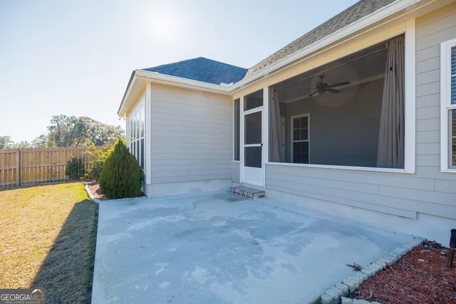a view of a swimming pool with lawn chairs under an umbrella