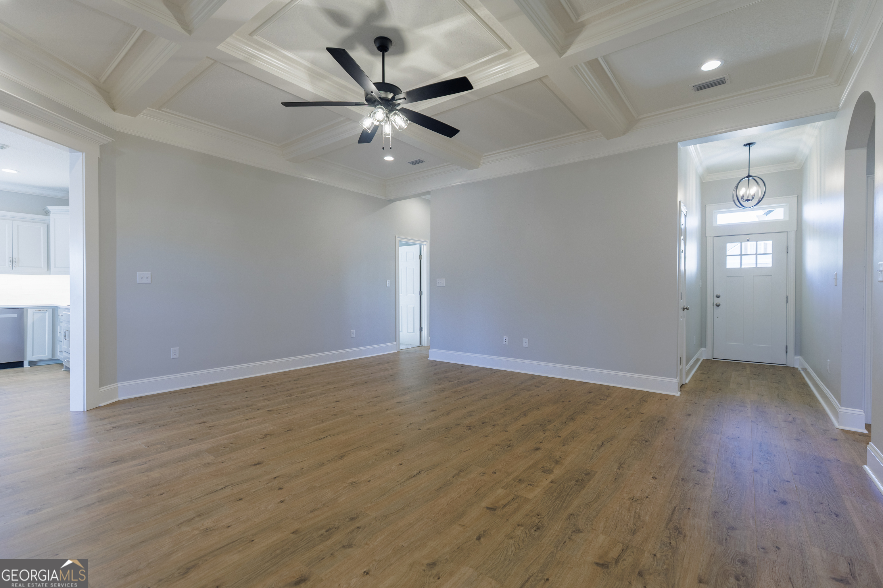 3001 Houser Way Hahira, GA 31632 - Photo 4 of 57 a view of an empty room with wooden floor and a ceiling fan