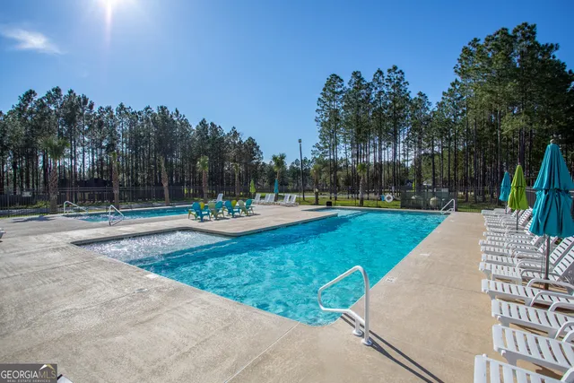an aerial view of residential houses with outdoor space and swimming pool