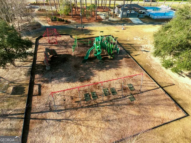 an aerial view of a house with a yard basket ball court and outdoor seating