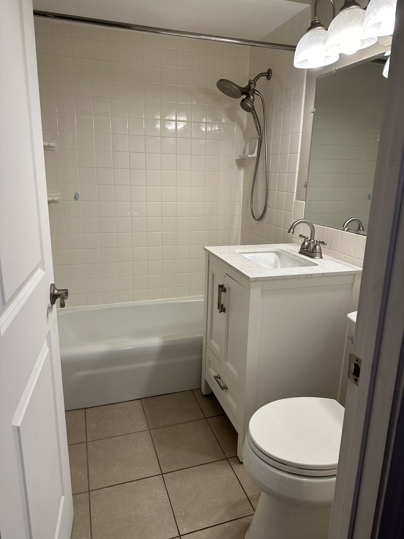 2327 Ogden Avenue, Unit 10 Downers Grove, IL 60515 - Photo 11 of 17 a bathroom with a granite countertop sink toilet and shower