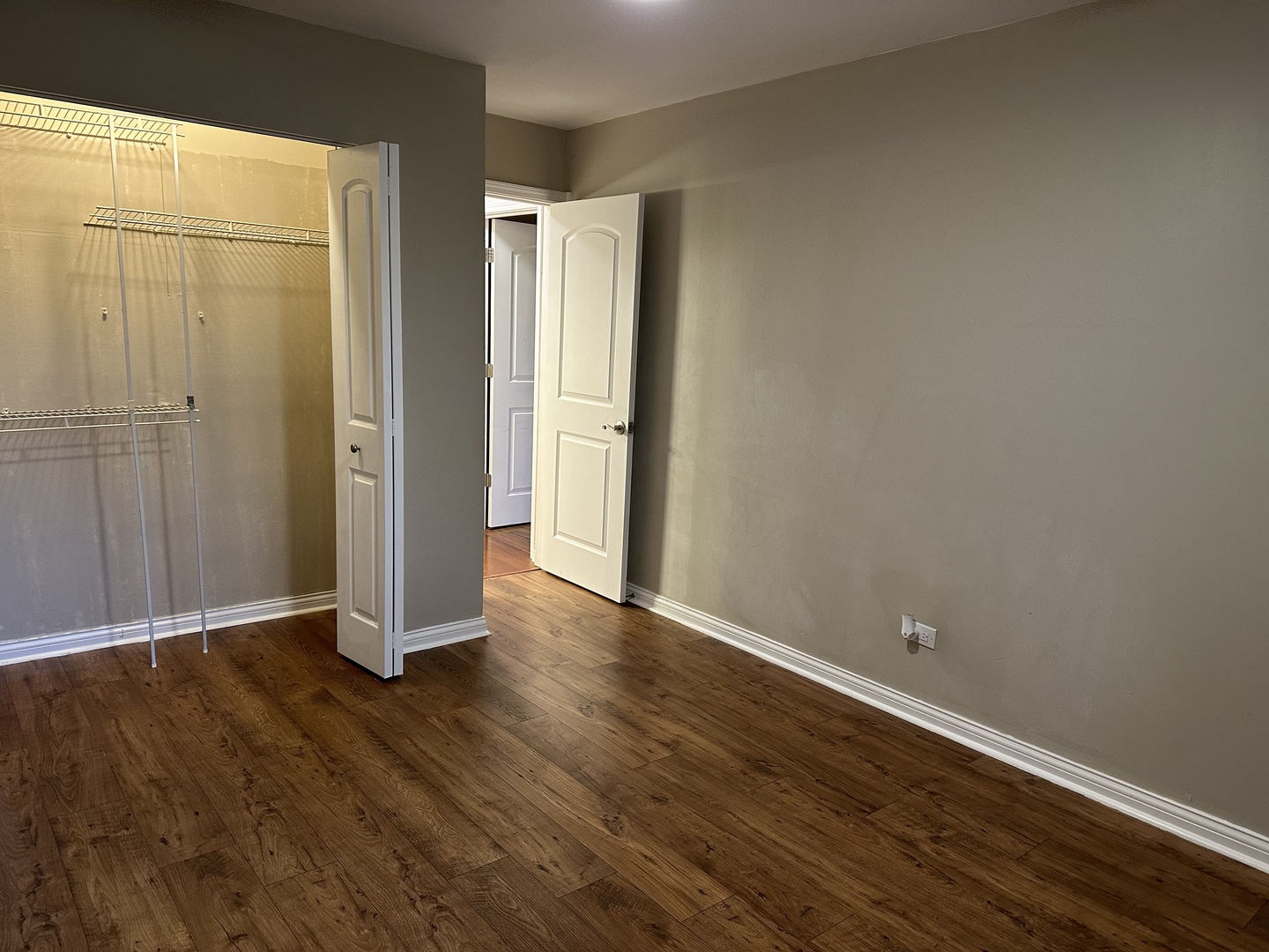2327 Ogden Avenue, Unit 10 Downers Grove, IL 60515 - Photo 13 of 17 a view of an empty room with wooden floor and a window
