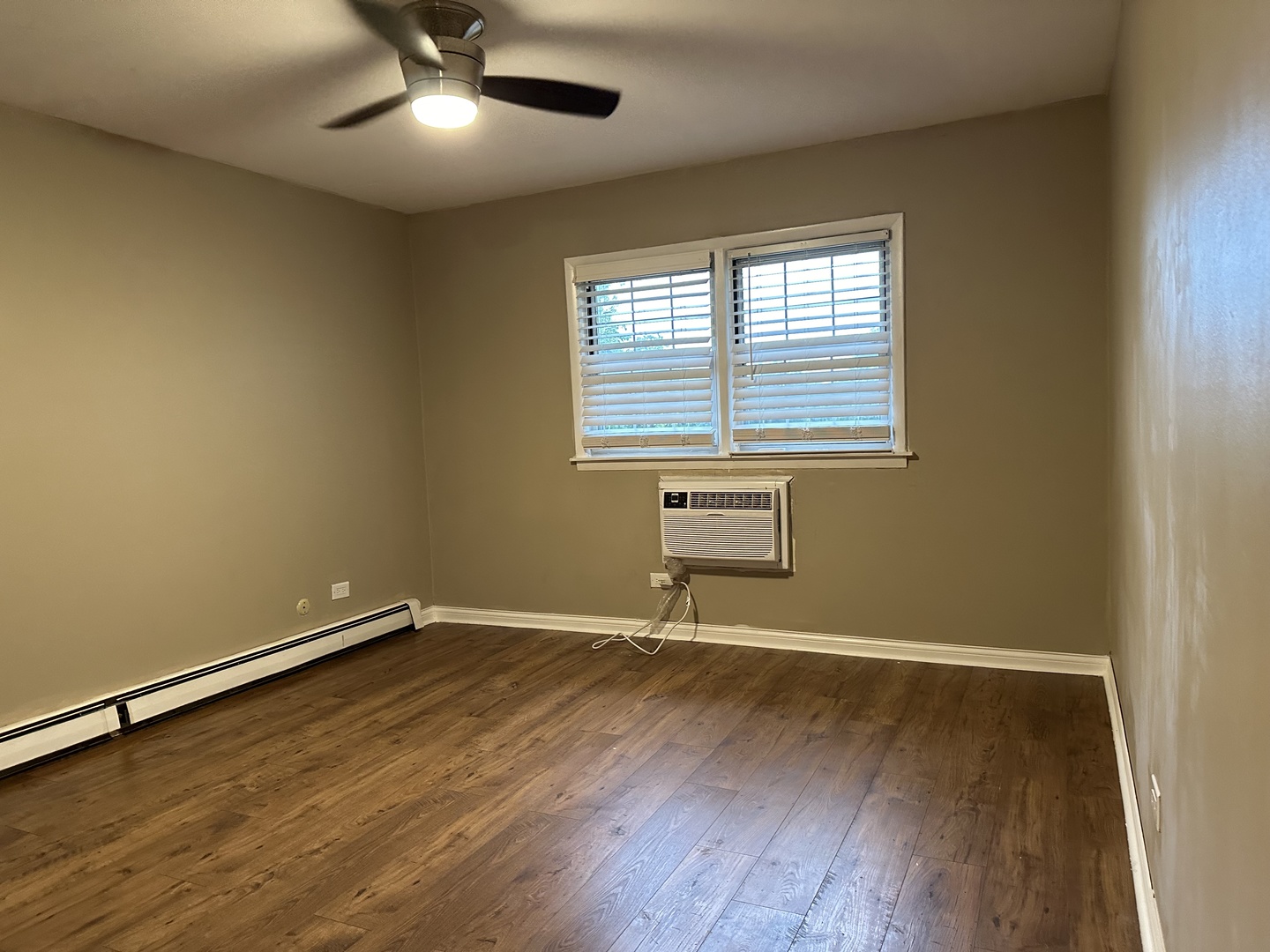 2327 Ogden Avenue, Unit 10 Downers Grove, IL 60515 - Photo 15 of 17 an empty room with wooden floor and windows