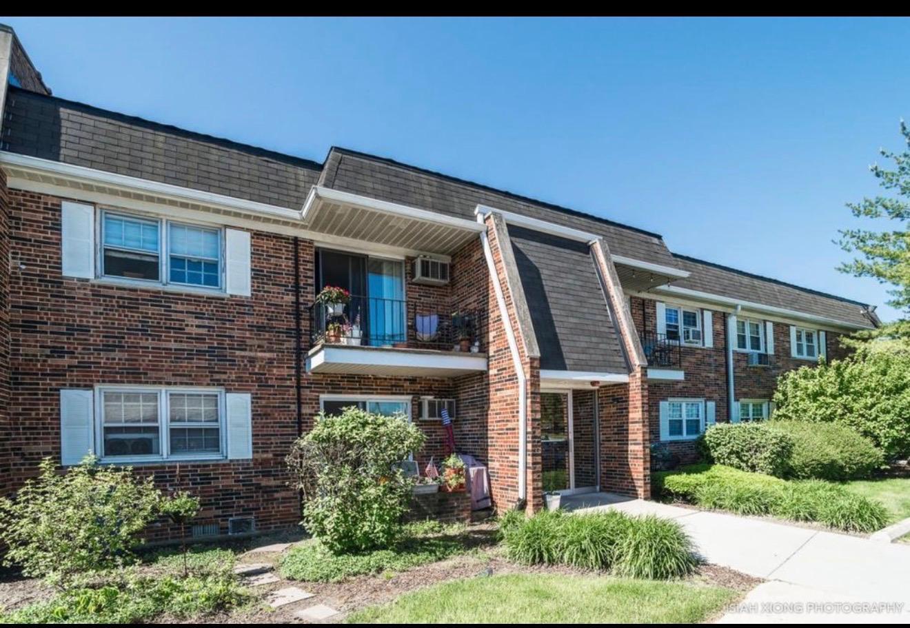 2327 Ogden Avenue, Unit 10 Downers Grove, IL 60515 - Photo 2 of 17 a front view of a house with garden