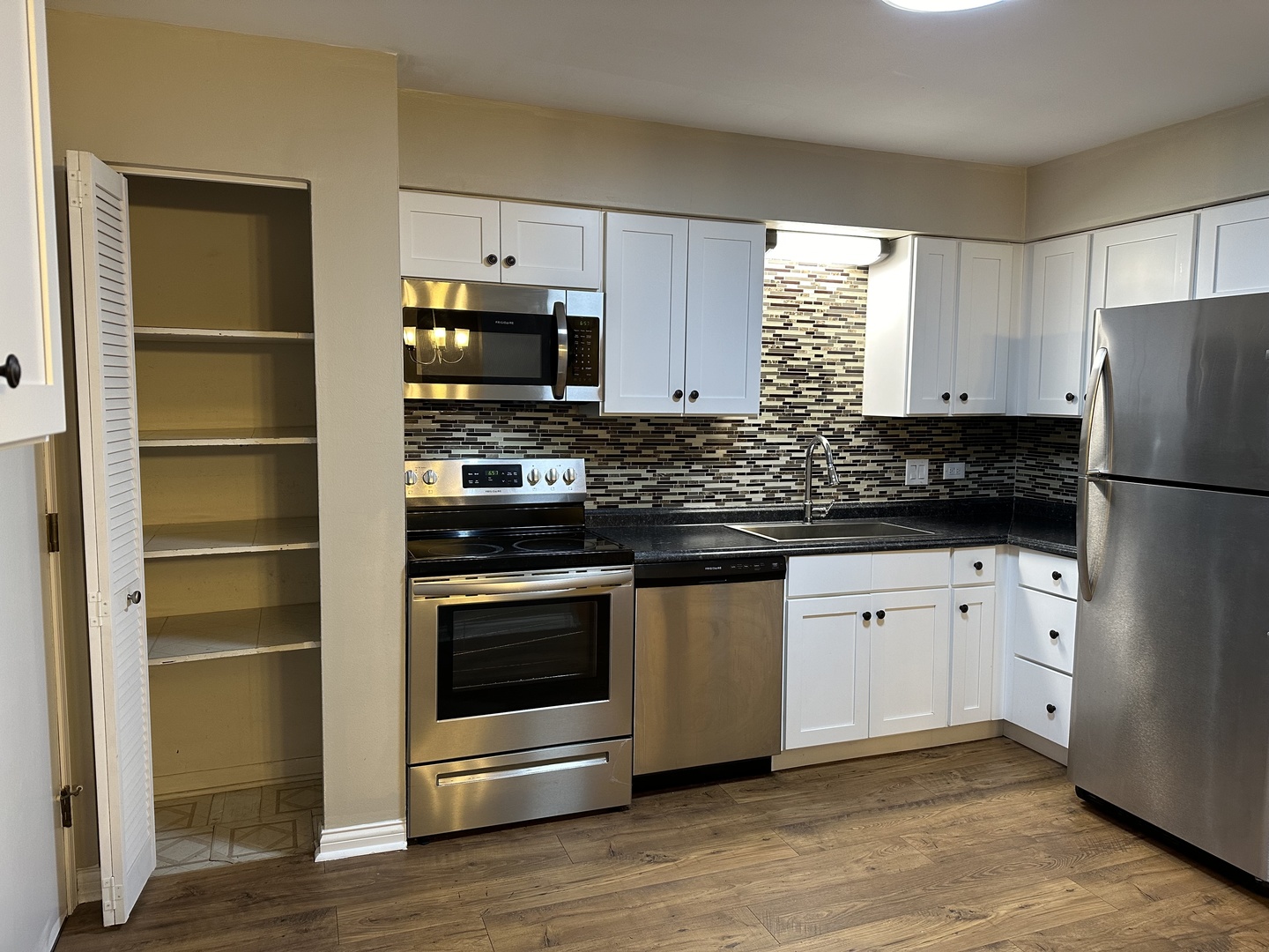 2327 Ogden Avenue, Unit 10 Downers Grove, IL 60515 - Photo 4 of 17 a kitchen with granite countertop a refrigerator stove and sink