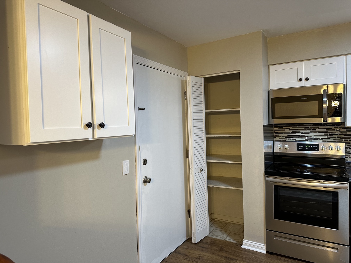 2327 Ogden Avenue, Unit 10 Downers Grove, IL 60515 - Photo 5 of 17 a kitchen with microwave a stove and a refrigerator