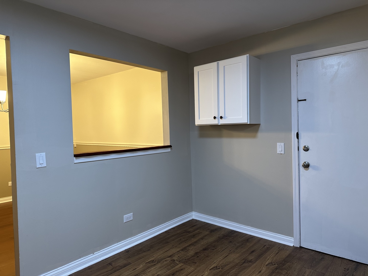 2327 Ogden Avenue, Unit 10 Downers Grove, IL 60515 - Photo 6 of 17 a view of an empty room with wooden floor and a window