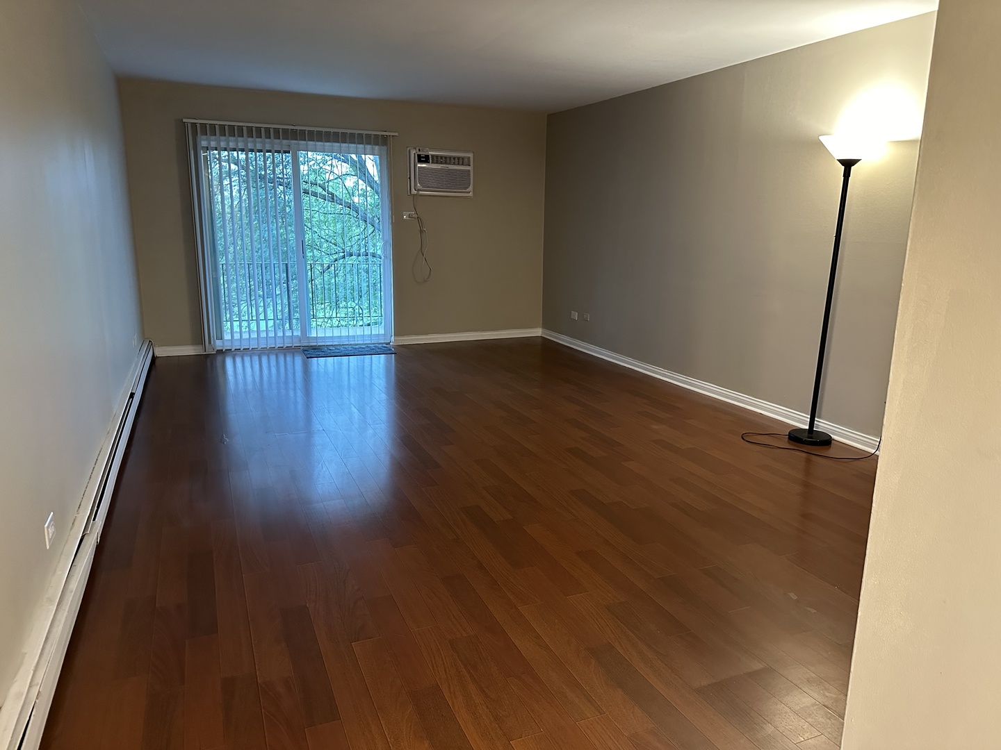 2327 Ogden Avenue, Unit 10 Downers Grove, IL 60515 - Photo 8 of 17 an empty room with wooden floor and windows