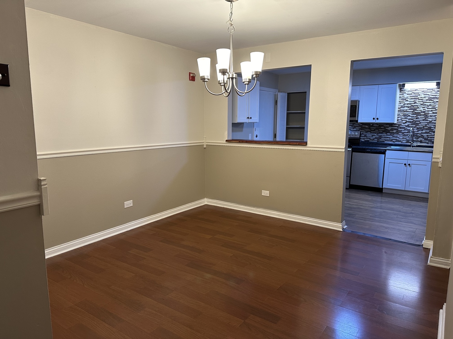 2327 Ogden Avenue, Unit 10 Downers Grove, IL 60515 - Photo 9 of 17 a view of a kitchen with wooden floor and a large window