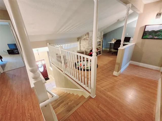 a view of entryway livingroom and hall with wooden floor