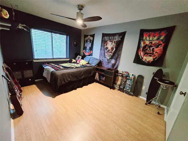 a bedroom with a bed dresser and furniture