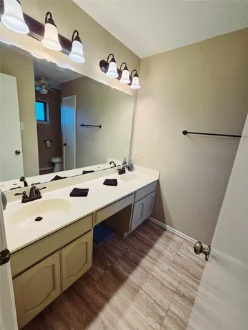 a bathroom with a double vanity sink and mirror
