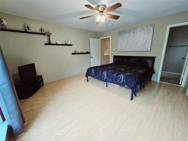 a spacious bedroom with a bed and window