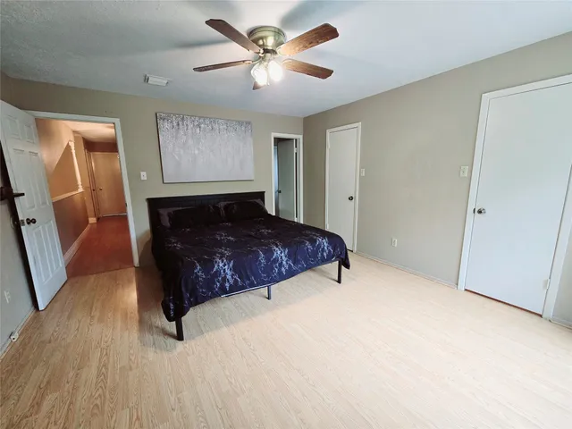 a large bed sitting in a room next to a window