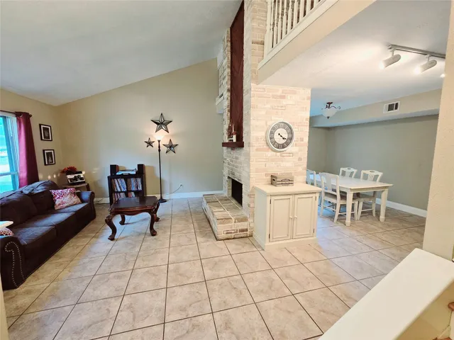 a living room with furniture a table and a clock