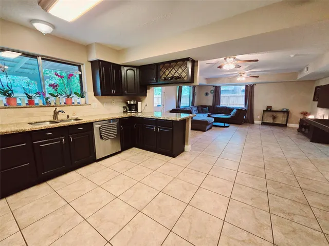 a kitchen with stainless steel appliances kitchen island granite countertop a sink and cabinets