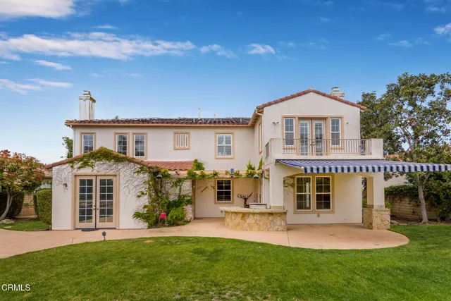 an aerial view of a house with a garden and swimming pool