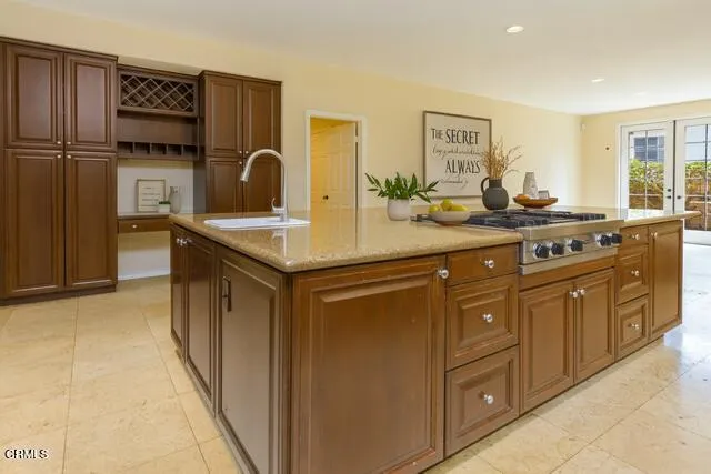 a spacious bedroom with a large bed a flat tv screen and a large window with the outer view