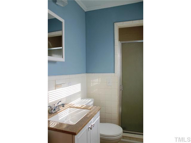 2301 Doran Place Raleigh, NC 27604 - Photo 11 of 11 a bathroom with a toilet a sink and mirror