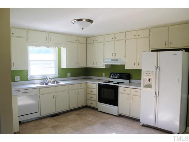 2301 Doran Place Raleigh, NC 27604 - Photo 7 of 11 a kitchen with stainless steel appliances granite countertop a stove a sink and a refrigerator