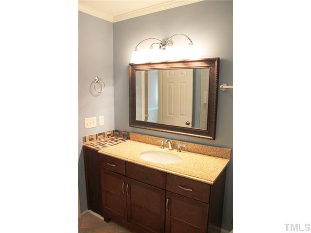 2301 Doran Place Raleigh, NC 27604 - Photo 8 of 11 a bathroom with a sink and a mirror