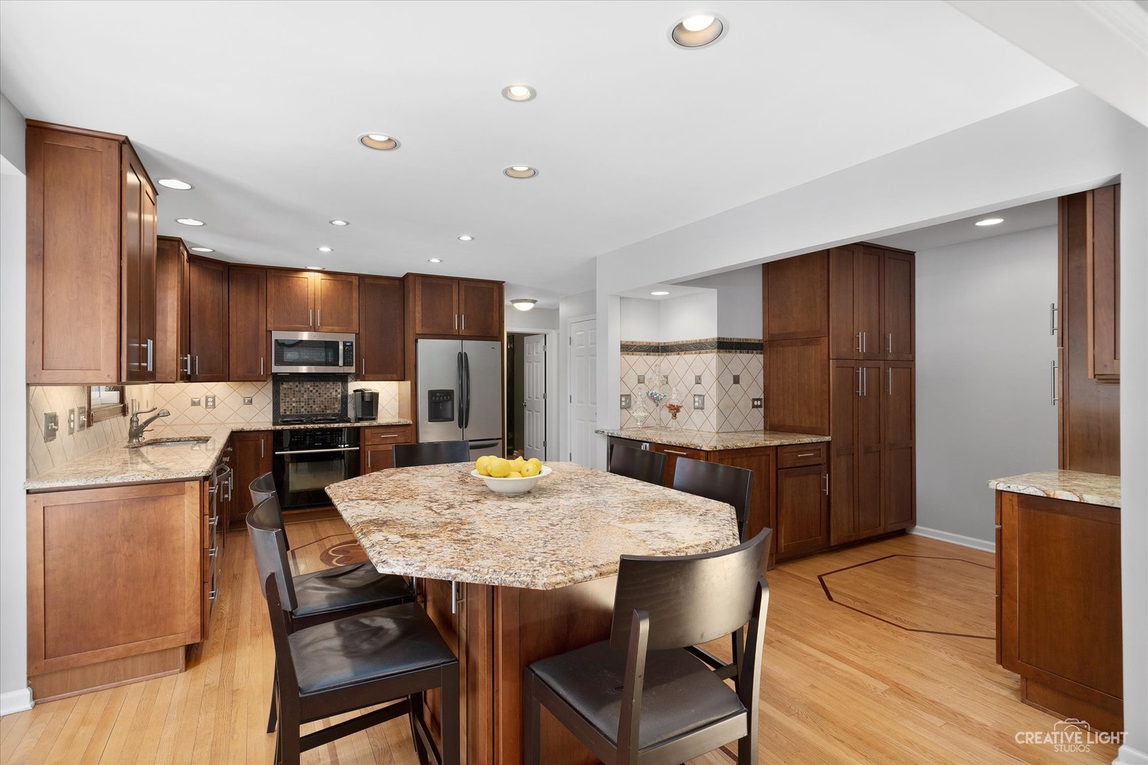 2636 Sweetbroom Road Naperville, IL 60564 - Photo 7 of 35 a kitchen with kitchen island wooden cabinets and refrigerator