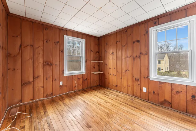 a view of a room with wooden floor and windows
