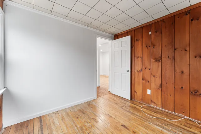 a view of a room with wooden floor