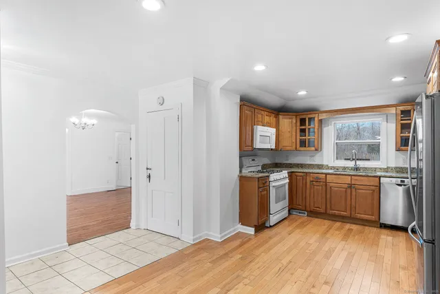 a kitchen with stainless steel appliances granite countertop a refrigerator and a stove top oven
