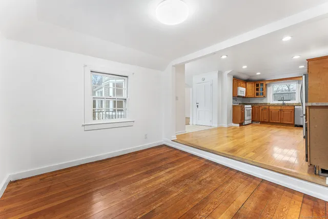 a big room with wooden floors and natural light