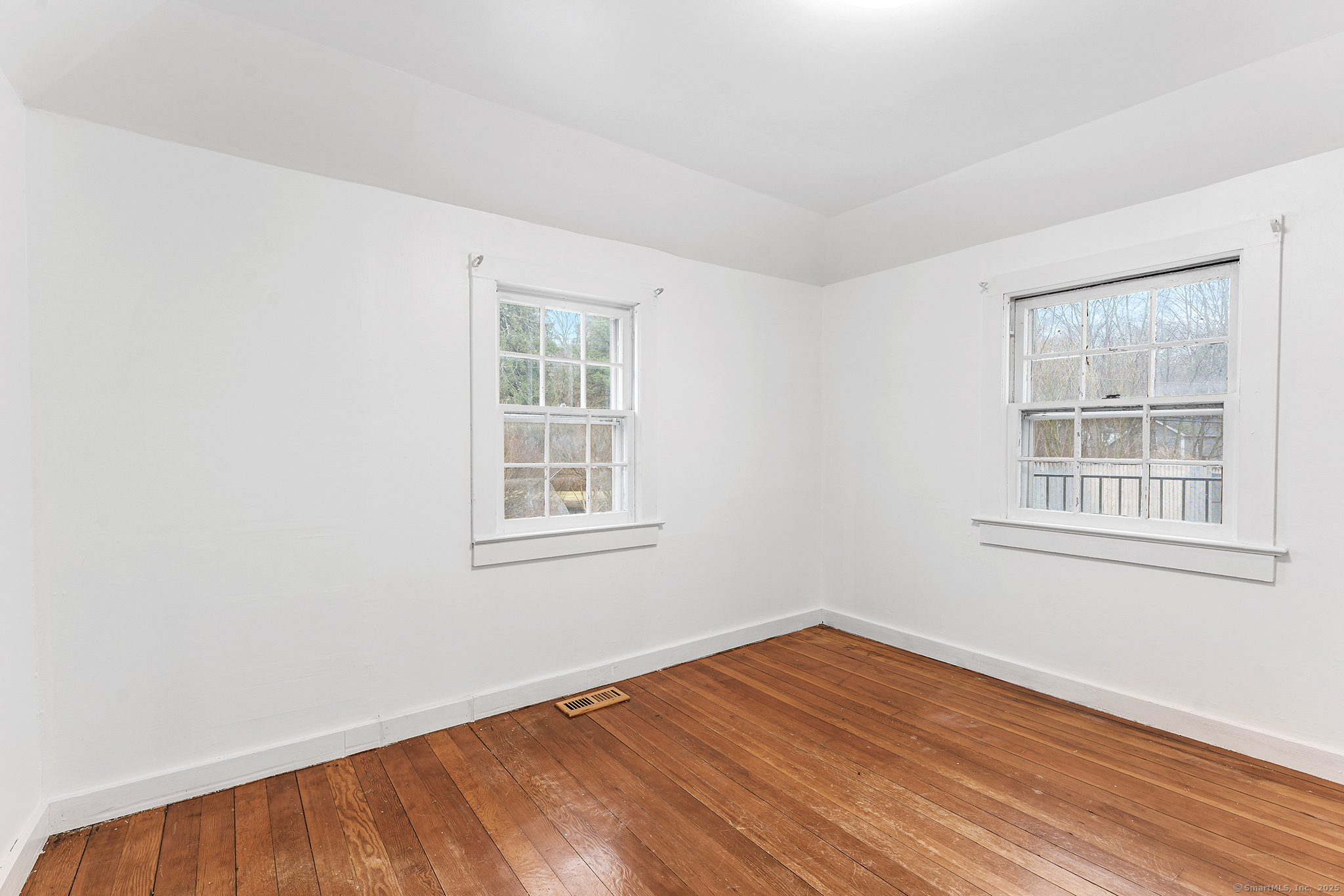 20 Georgetown Road Weston, CT 06883 - Photo 9 of 30 an empty room with wooden floor and windows