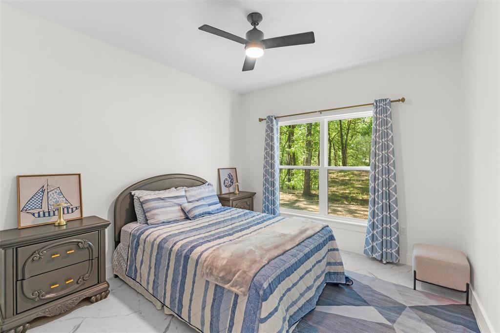 265 Shadow Oaks Streetman, TX 75859 - Photo 13 of 40 a bedroom with a bed and a window