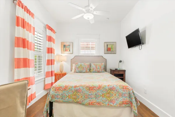 a view of a house with a yard and potted plants