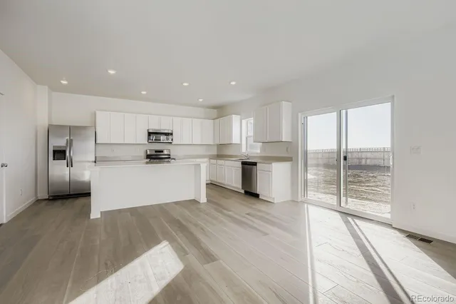 a view of kitchen with wooden floor