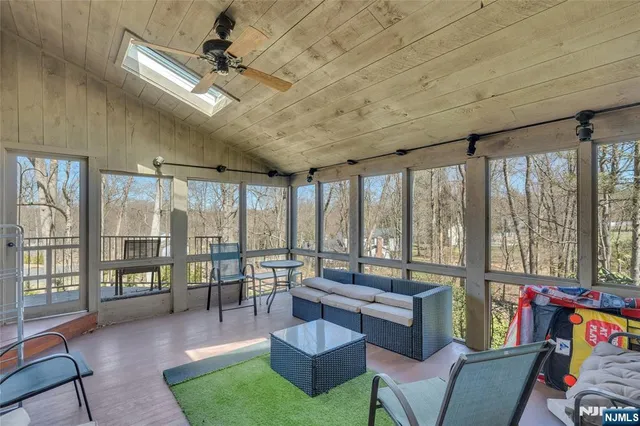 a living room with furniture and a floor to ceiling window