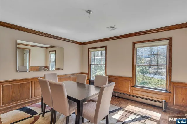 a view of a a dining room with furniture window and wooden floor