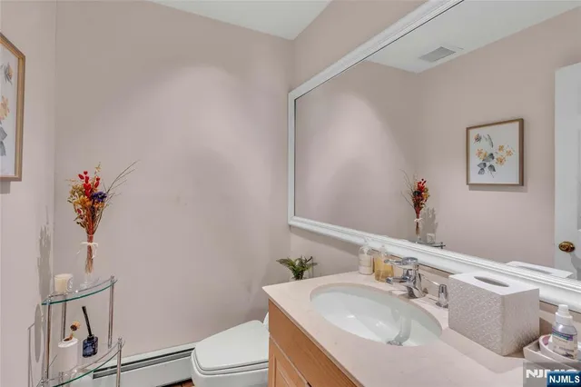 a bathroom with a sink a toilet and a mirror