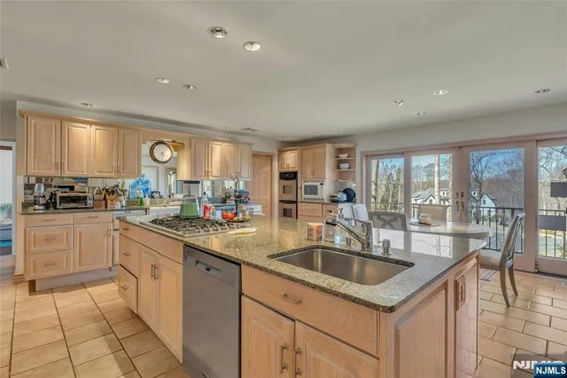 a kitchen with granite countertop a sink and cabinets