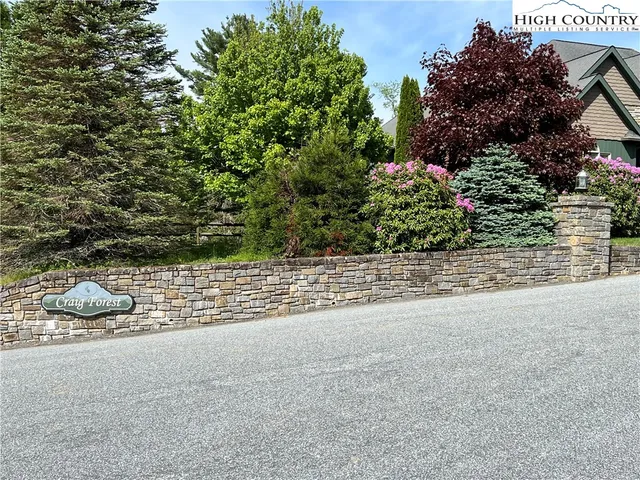a green field with some trees in the background
