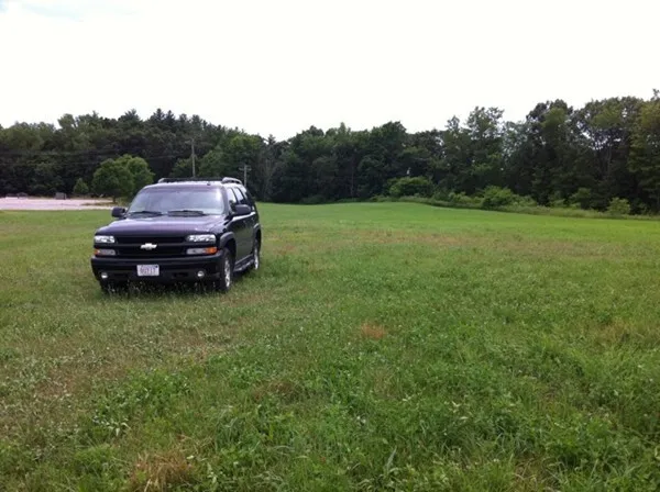 a car parked in the middle of a field