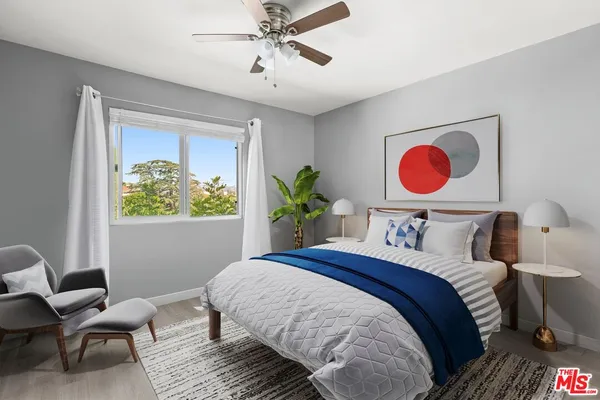 a bedroom with a bed and a chandelier