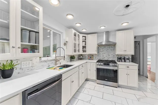 a kitchen with stainless steel appliances granite countertop a sink and cabinets