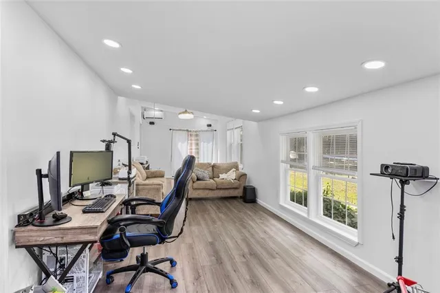 a work room with furniture and a flat screen tv
