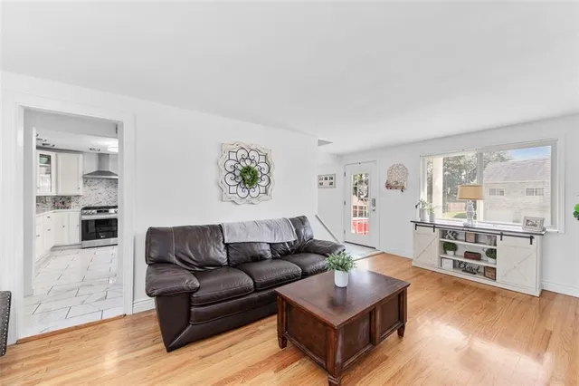 a living room with furniture and a kitchen view