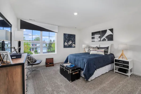 a bedroom with a bed and a couch