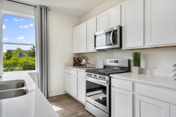 a kitchen with stainless steel appliances granite countertop a stove and a sink