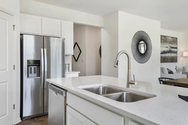 a kitchen with a refrigerator and a sink